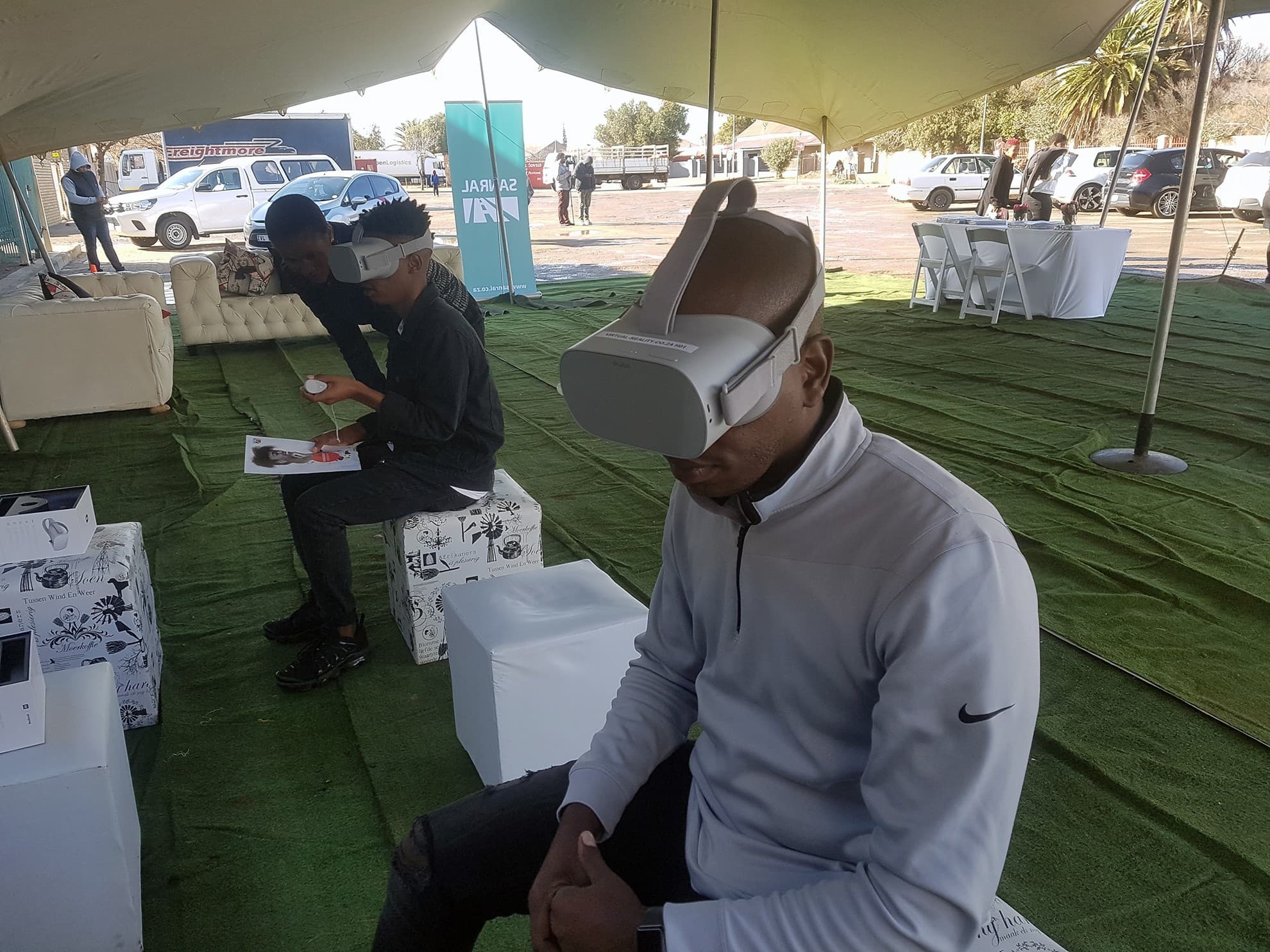 Facilitator sanitizing headsets between user sessions