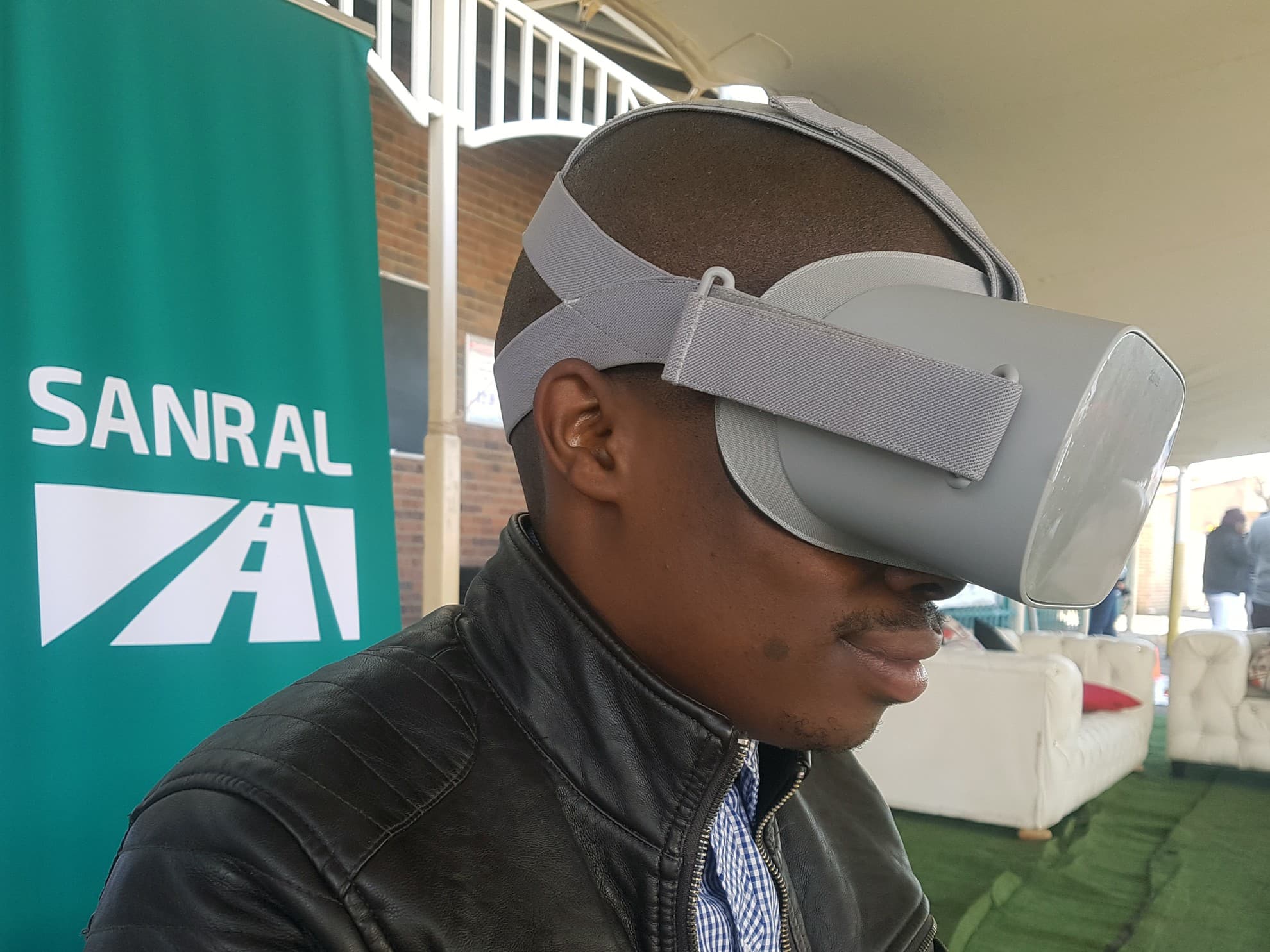 SANRAL branding with attendees using VR headsets