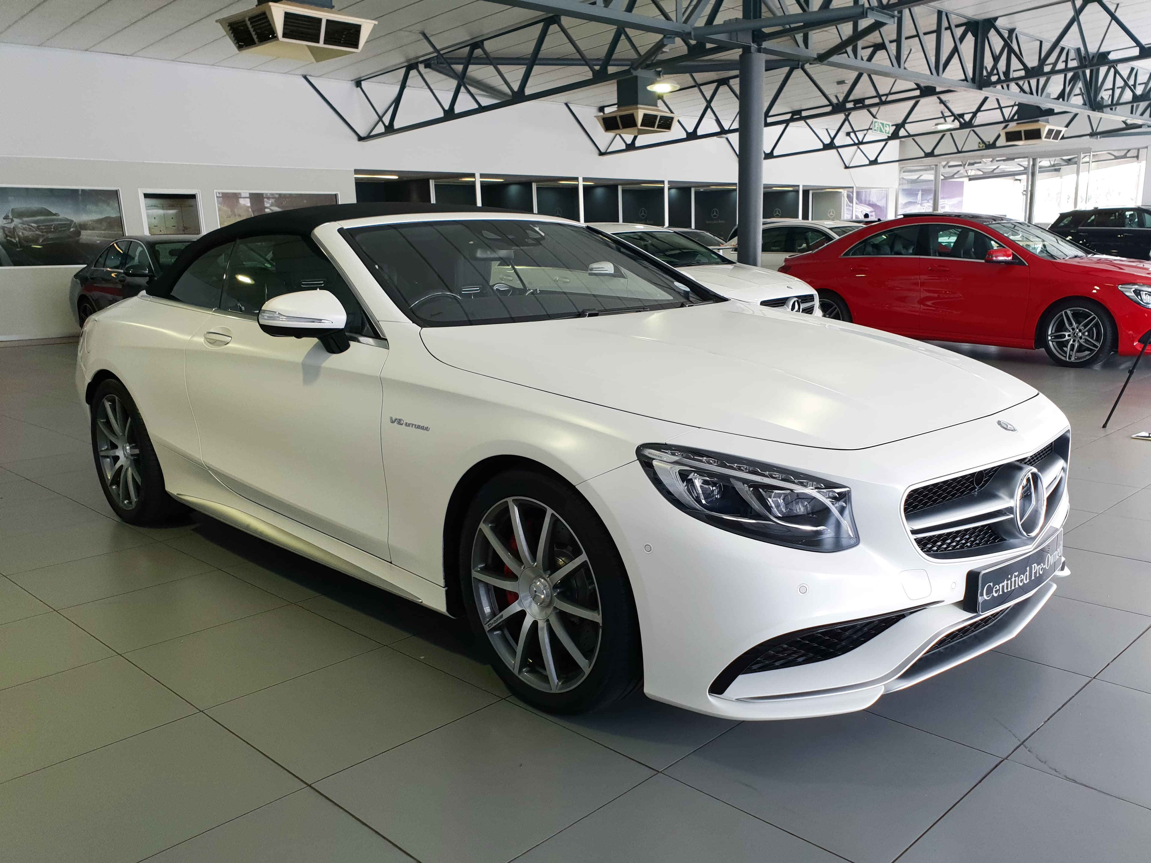 White Mercedes-Benz photographed inside a dealership showroom
