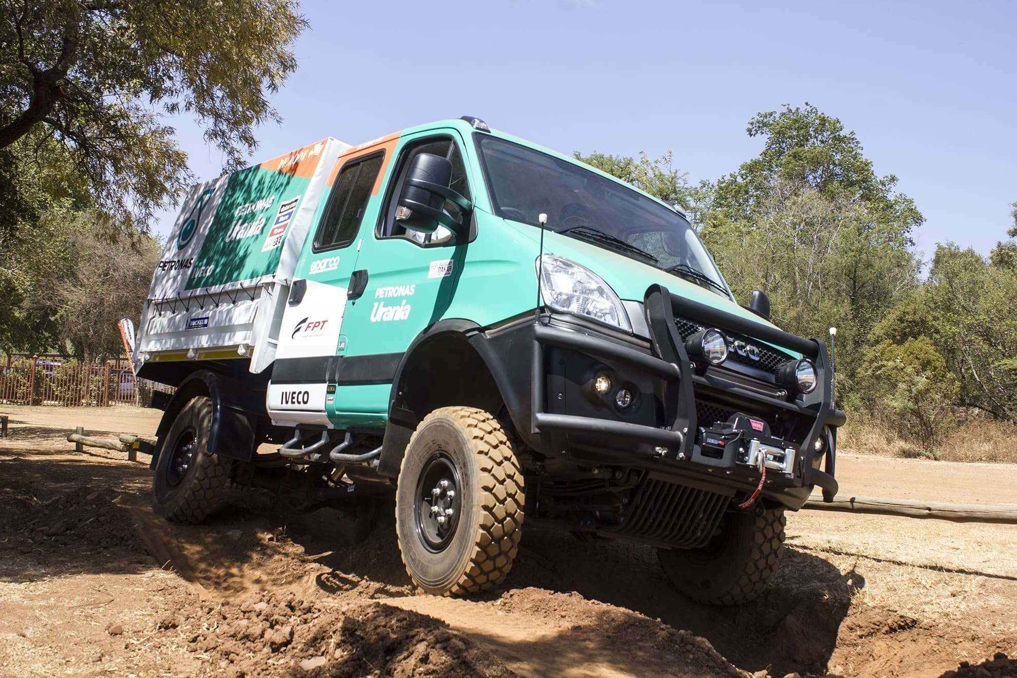 An Iveco truck driving on uneven ground