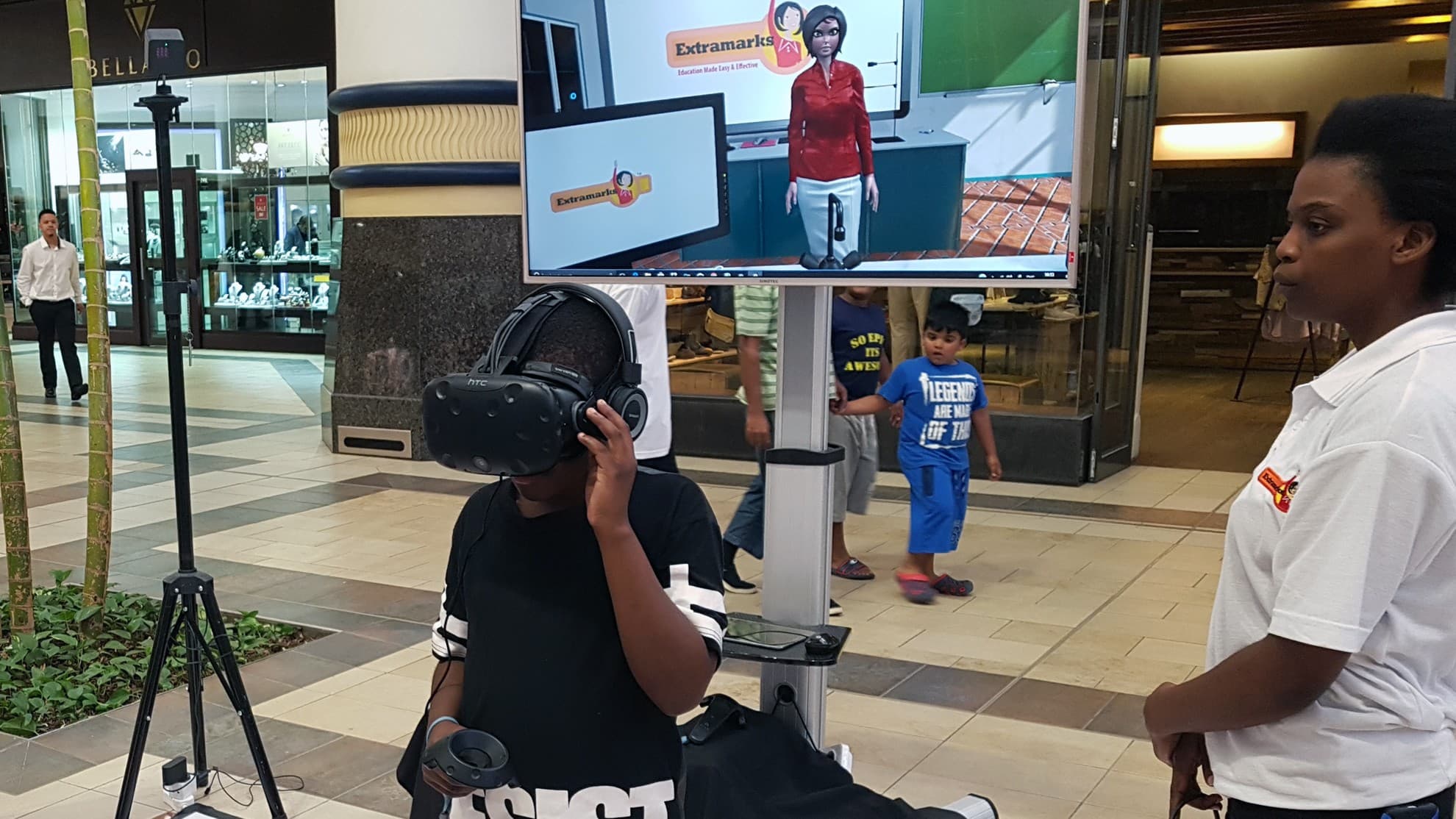 A participant exploring a VR learning experience with a facilitator nearby
