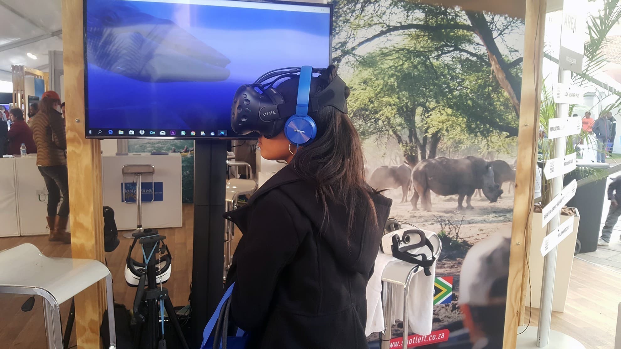 A participant wearing a headset at the South African Tourism stand