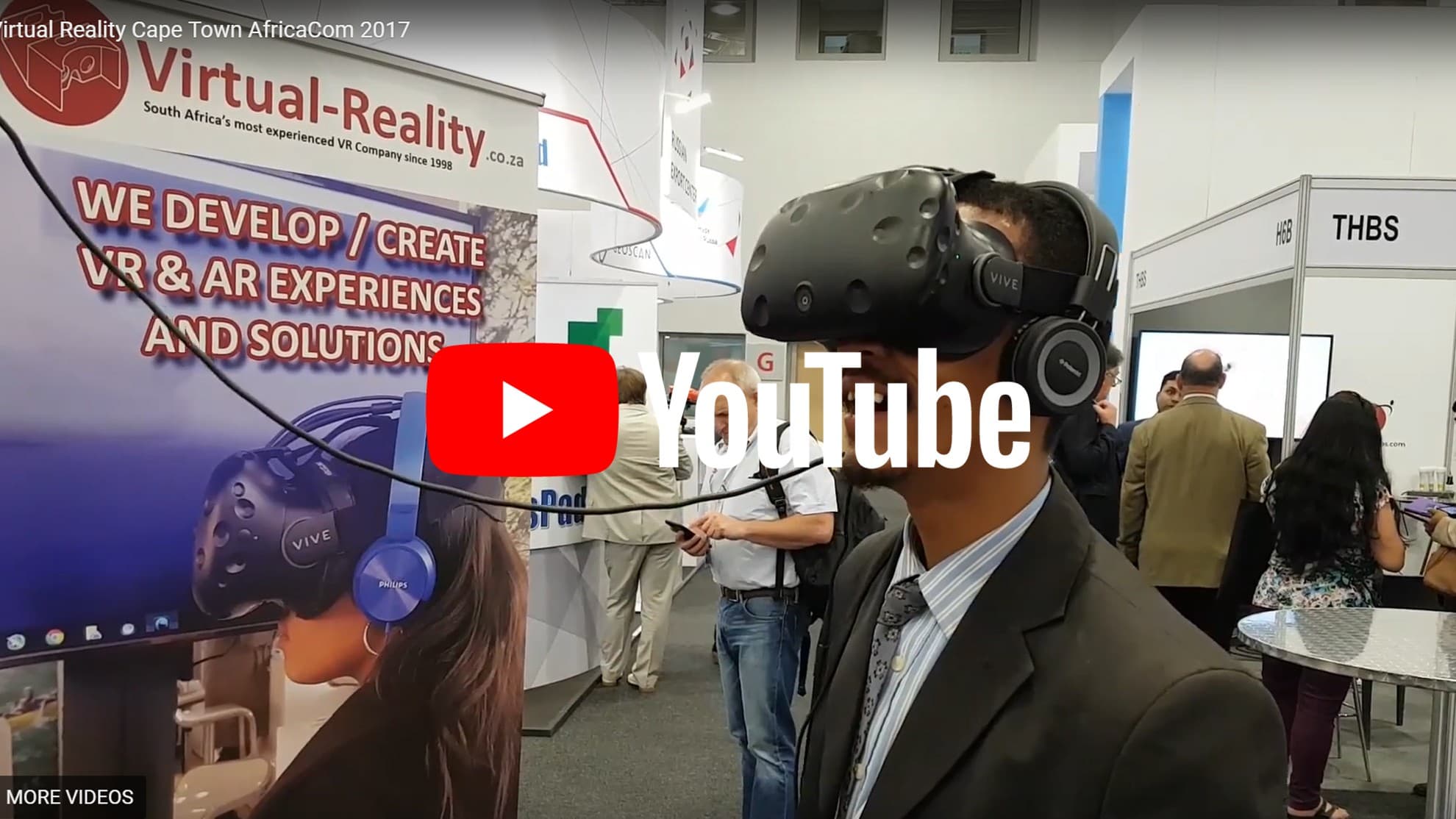 A participant trying a headset at a Virtual Reality event stand