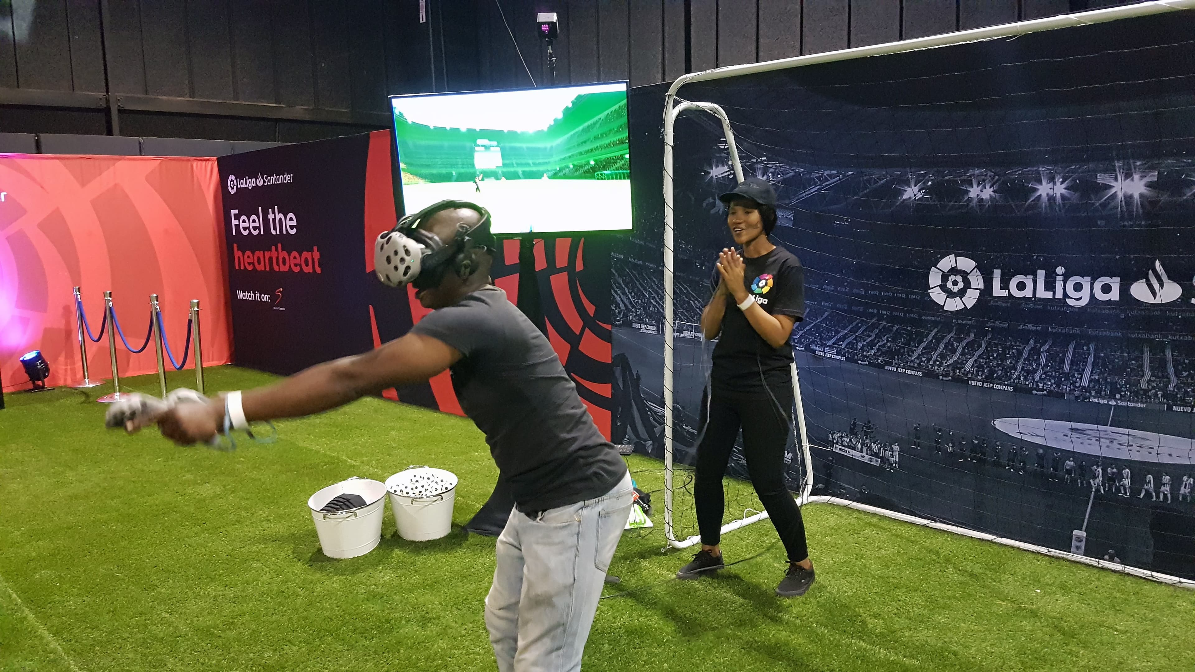 A participant playing virtual reality soccer at a La Liga activation