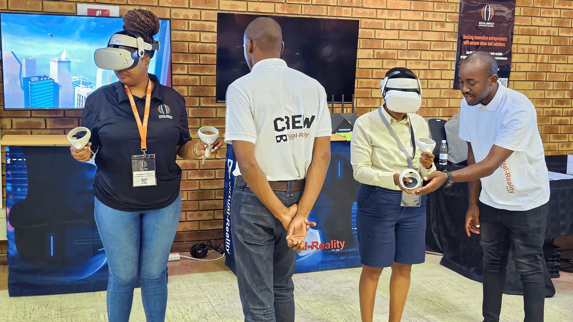 Virtual Reality South Africa team members helping participants try VR headsets and controllers