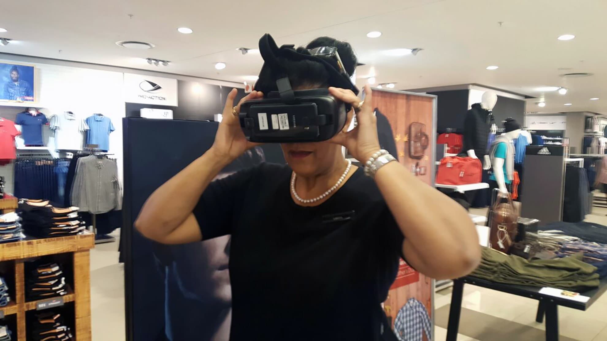 Participant adjusting a Gear VR headset at an exhibition