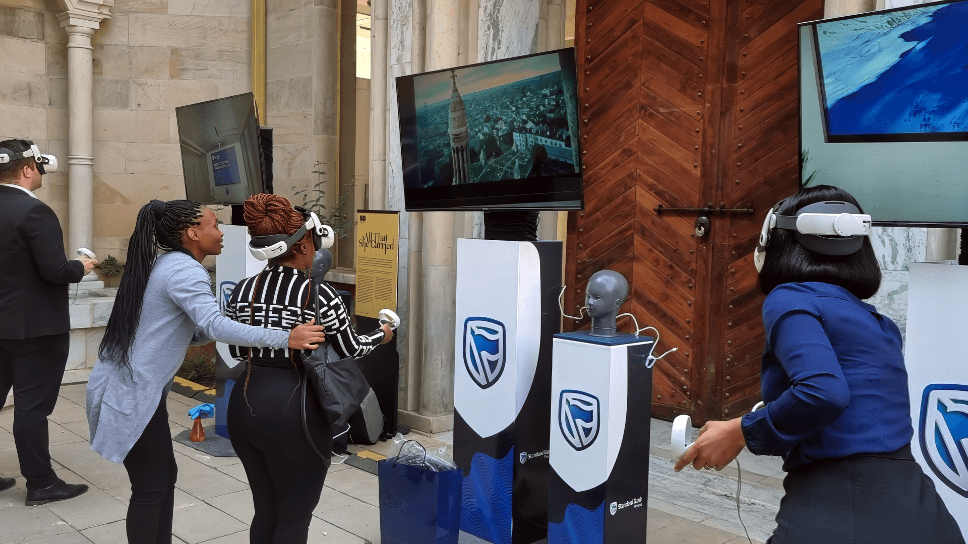 Participants using VR headsets and controllers at a Standard Bank activation
