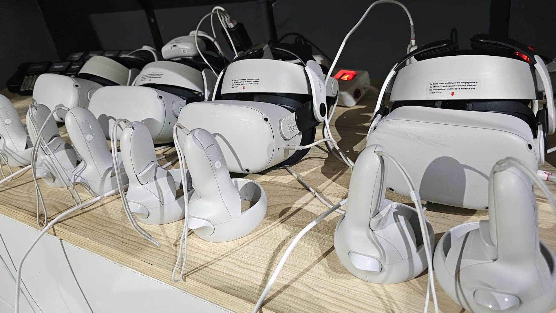 A collection of VR headsets and headphones prepared together on a table