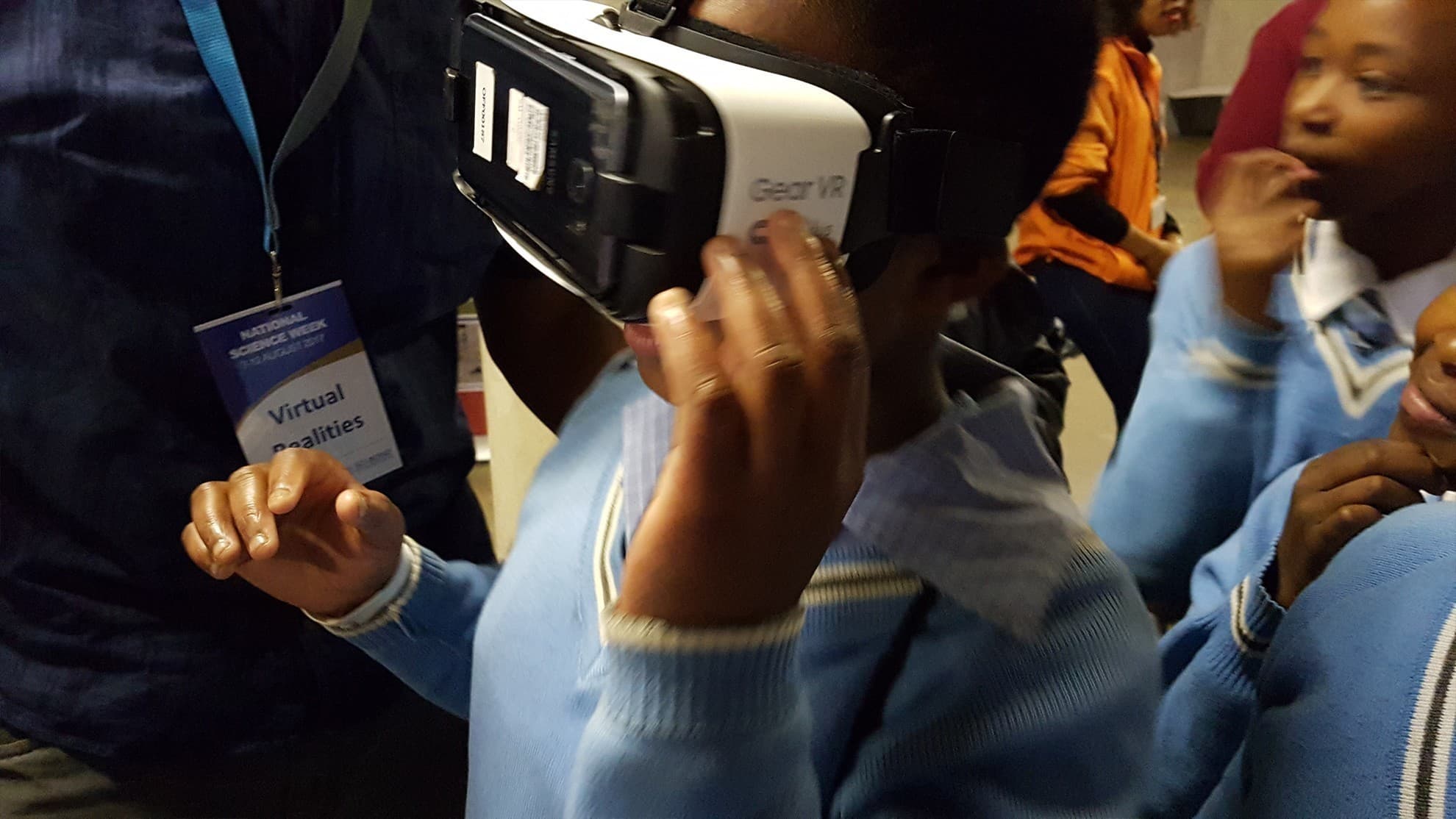Participant holding a Gear VR headset during an experience