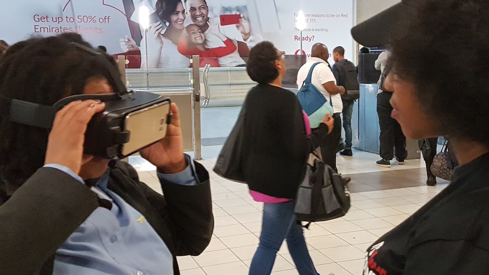 Facilitator helping a guest fit a VR headset