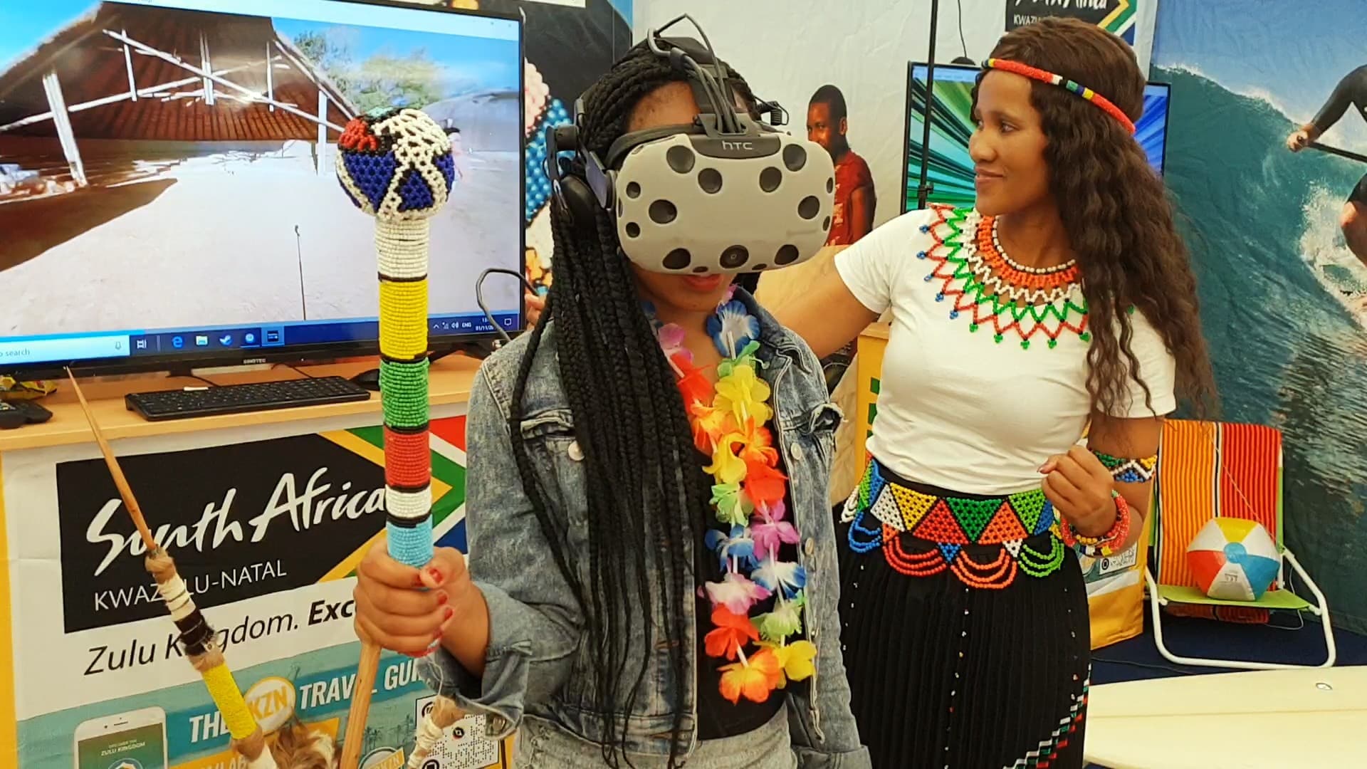 A visitor wearing an HTC Vive headset alongside a facilitator at a KwaZulu-Natal tourism activation